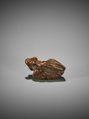KOKEI: A WOOD NETSUKE OF A RECUMBENT OX