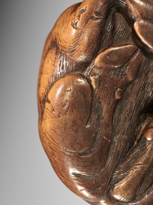 KOKEI: A WOOD NETSUKE OF A RECUMBENT OX