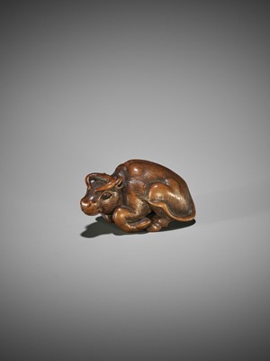 KOKEI: A WOOD NETSUKE OF A RECUMBENT OX