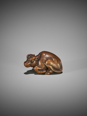 KOKEI: A WOOD NETSUKE OF A RECUMBENT OX