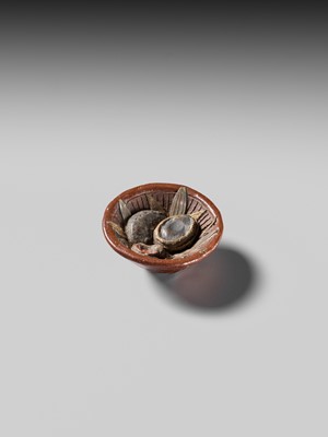 Lot 494 - NOMURA CHOHEI: A RARE LACQUERED AND INLAID CERAMIC NETSUKE OF A MORTAR WITH SHELLS