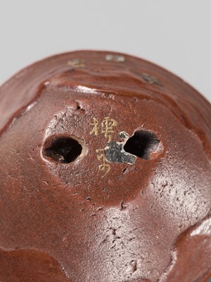 Lot 494 - NOMURA CHOHEI: A RARE LACQUERED AND INLAID CERAMIC NETSUKE OF A MORTAR WITH SHELLS
