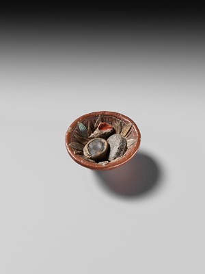 Lot 494 - NOMURA CHOHEI: A RARE LACQUERED AND INLAID CERAMIC NETSUKE OF A MORTAR WITH SHELLS