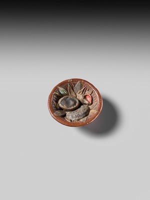 Lot 494 - NOMURA CHOHEI: A RARE LACQUERED AND INLAID CERAMIC NETSUKE OF A MORTAR WITH SHELLS