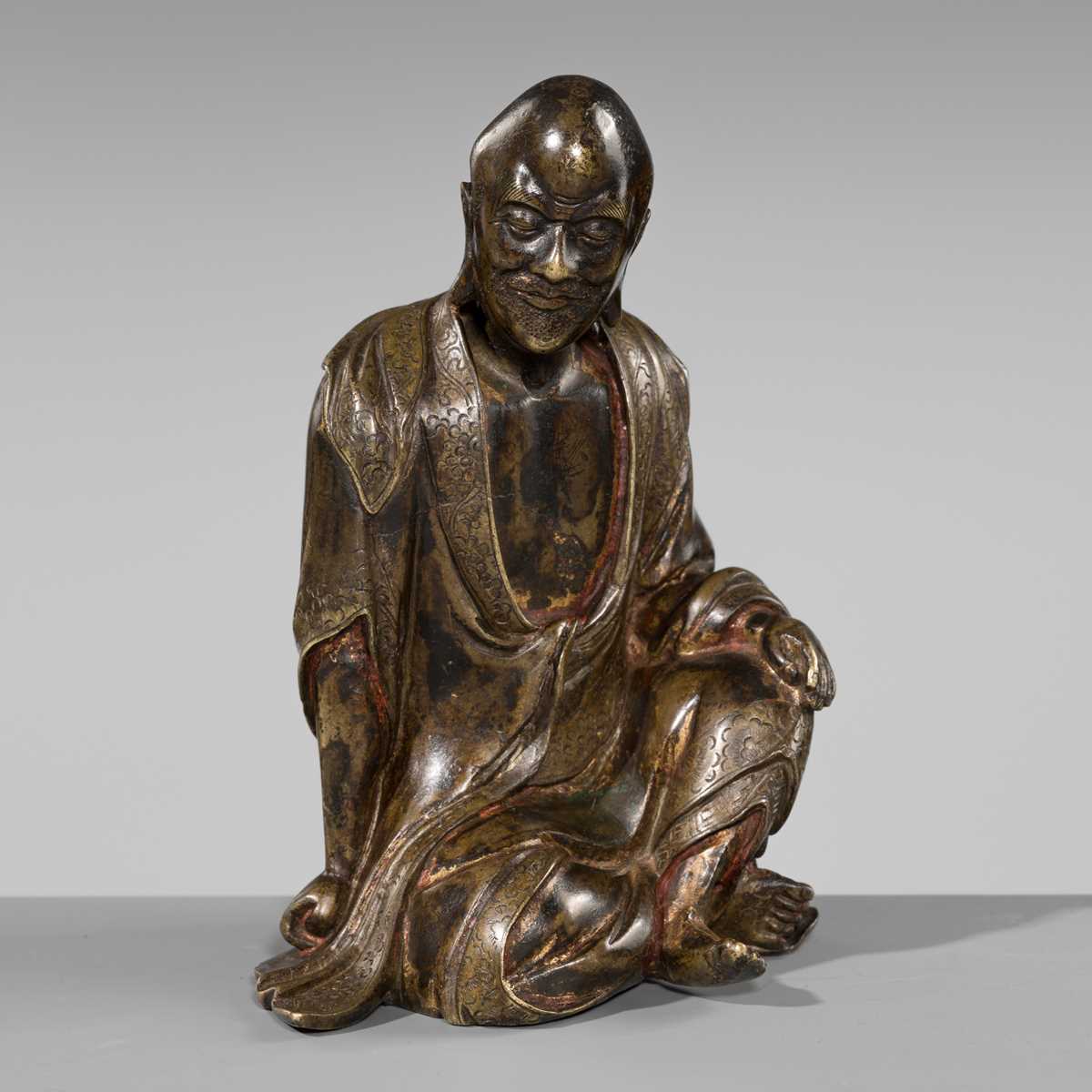 Lot 55 - A RARE BRONZE FIGURE OF A LUOHAN, YUAN-MING DYNASTY