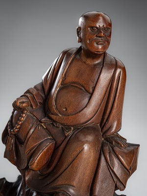 Lot 862 - A WOOD FIGURE OF A LUOHAN, EARLY QING DYNASTY