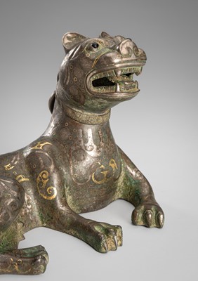 Lot 799 - AN ARCHAISTIC GOLD AND SILVER-INLAID BRONZE FIGURE OF A MYTHICAL BEAST