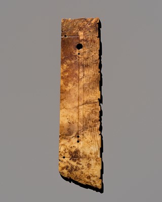AN UNUSUALLY LARGE AND INCISED WHITE AND RUSSET JADE NOTCHED RITUAL BLADE, LATE SHANG DYNASTY, ANYANG PHASE