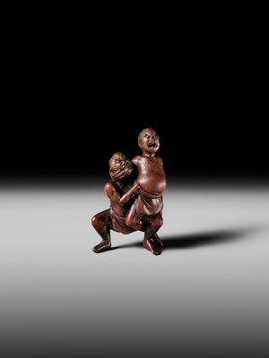 Lot 194 - ITTAN: A WOOD NETSUKE OF TWO SUMO WRESTLERS