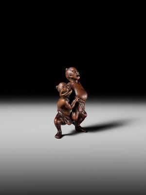 Lot 194 - ITTAN: A WOOD NETSUKE OF TWO SUMO WRESTLERS