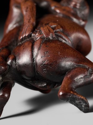Lot 194 - ITTAN: A WOOD NETSUKE OF TWO SUMO WRESTLERS
