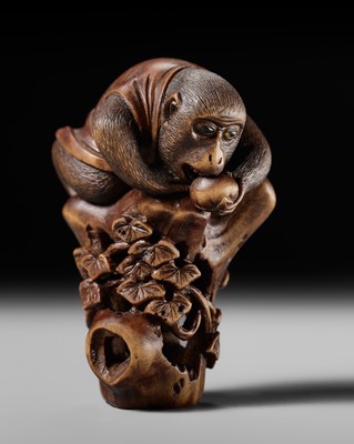 Lot 195 - TOMOKAZU: A FINE WOOD NETSUKE OF A MONKEY ON A TREE STUMP EATING A PERSIMMON