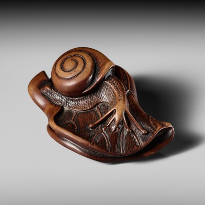 Lot 218 - A FINE WOOD NETSUKE OF A SNAIL ON A LOTUS LEAF