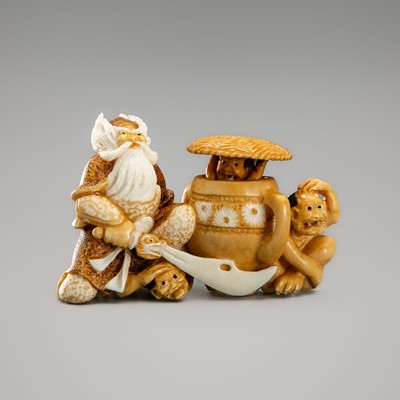 Lot 758 - ALEXANDER DERKACHENKO: A CONTEMPORARY MAMMOTH TUSK KARAKURI (TRICK) NETSUKE OF SHOKI AND THREE ONI