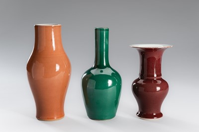 Lot 1200 - A GROUP OF THREE MONOCHROME GLAZED PORCELAIN VASES, LATE QING DYNASTY TO REPUBLIC PERIOD