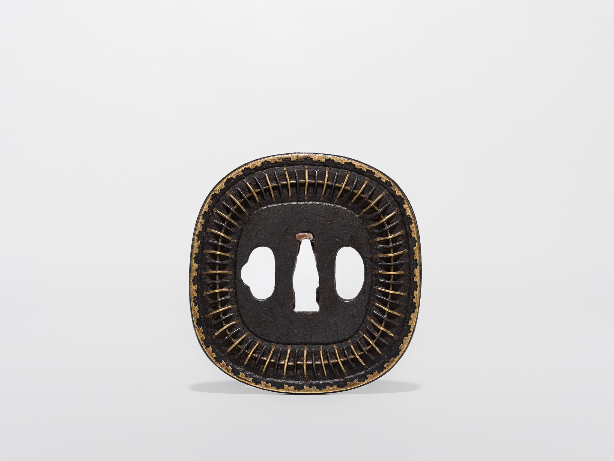 Lot 550 - A FINE IRON AND BRASS SHINGEN MUKADE TSUBA,