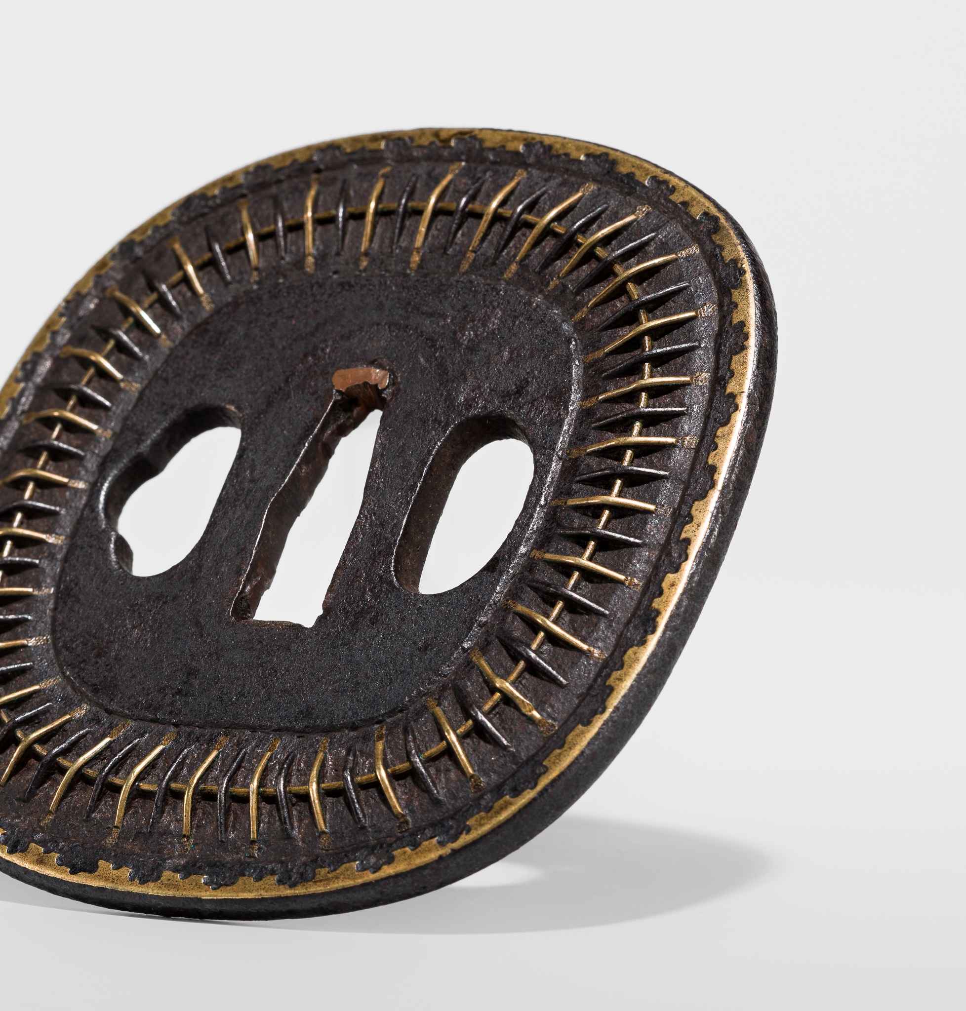 Lot 550 - A FINE IRON AND BRASS SHINGEN MUKADE TSUBA,