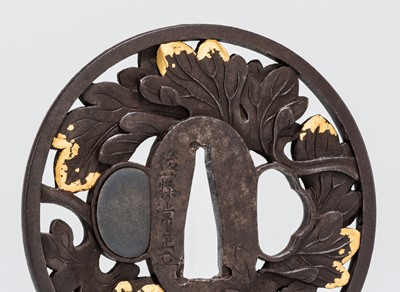 Lot 546 - GOTO TSUNEMASA: A FINE IRON SUKASHI TSUBA CHOSHU SCHOOL WITH GOLD-INLAID IVY LEAVES