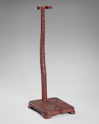 Lot 519 - A FINE TSUISHU (CARVED RED LACQUER) TACHI-KAKE (SWORD STAND)