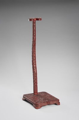 Lot 519 - A FINE TSUISHU (CARVED RED LACQUER) TACHI-KAKE (SWORD STAND)