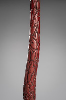 Lot 519 - A FINE TSUISHU (CARVED RED LACQUER) TACHI-KAKE (SWORD STAND)