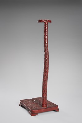 Lot 519 - A FINE TSUISHU (CARVED RED LACQUER) TACHI-KAKE (SWORD STAND)