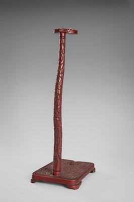 Lot 519 - A FINE TSUISHU (CARVED RED LACQUER) TACHI-KAKE (SWORD STAND)