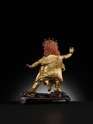 Lot 21 - A GILT-BRONZE FIGURE OF NILAMBARA VAJRAPANI, TIBET, 16TH-17TH CENTURY
