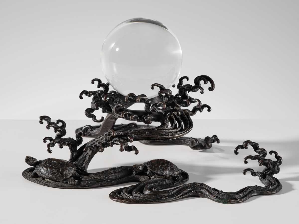 Lot 14 - YOSHIAKA: A BRONZE WAVE-FORM 'CRYSTAL SPHERE' STAND WITH TURTLES