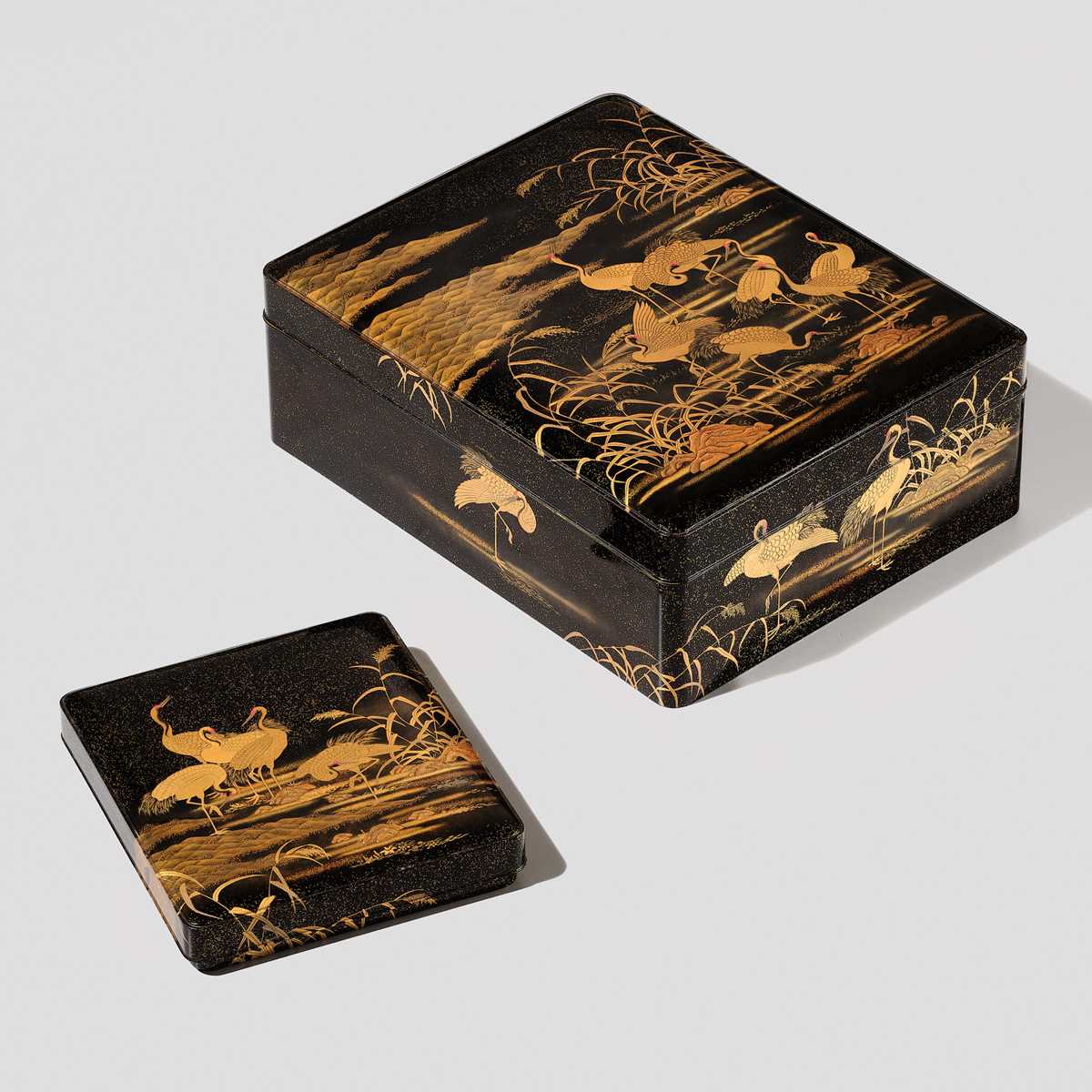 AN IMPRESSIVE MATCHING SET OF A RYOSHIBAKO (DOCUMENT BOX) AND SUZURIBAKO (WRITING BOX) WITH CRANES, YOUNG PINES AND THE RISING SUN AND MOON