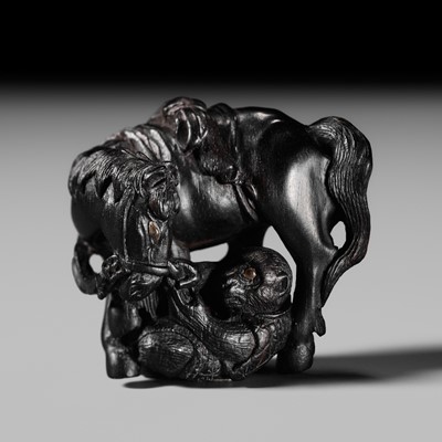Lot 73 - HASEGAWA IKKO: A SUPERB EBONY WOOD NETSUKE OF A HORSE AND MONKEY