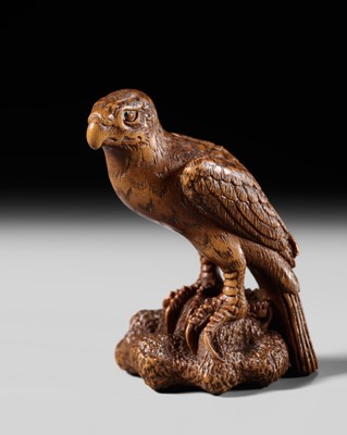 Lot 176 - HARUMITSU: A FINE WOOD NETSUKE OF AN EAGLE PERCHED ON A ROCK