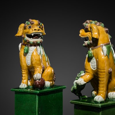 Lot 255 - A FINE PAIR OF SANCAI-GLAZED BISCUIT PORCELAIN FIGURES OF BUDDHIST LIONS, QING DYNASTY