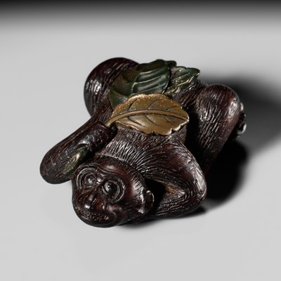 Lot 355 - A LACQUERED AND INLAID WOOD NETSUKE OF SARU KANI GASSEN