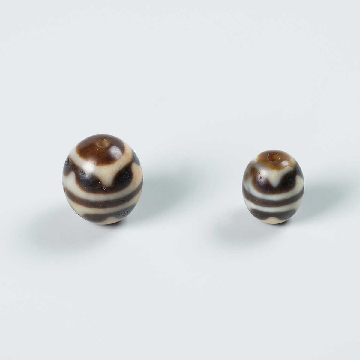 Lot 50 - TWO AGATE CHUNG DZI BEADS