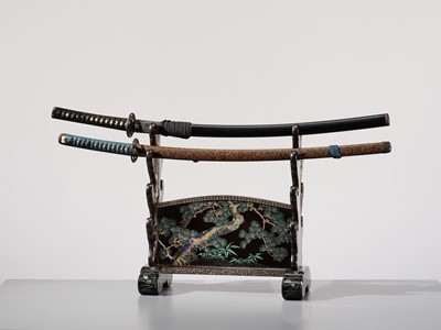 Lot 135 - A SUPERB MOTHER-OF-PEARL INLAID AND BLACK-LACQUERED ‘THREE FRIENDS OF WINTER (SHOCHIKUBAI)’ KATANA-KAKE (SWORD STAND)