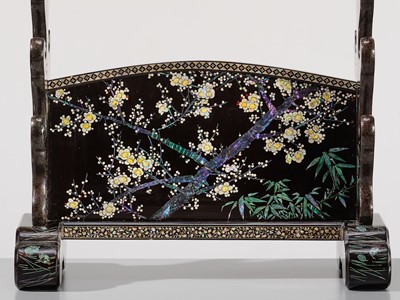 Lot 135 - A SUPERB MOTHER-OF-PEARL INLAID AND BLACK-LACQUERED ‘THREE FRIENDS OF WINTER (SHOCHIKUBAI)’ KATANA-KAKE (SWORD STAND)