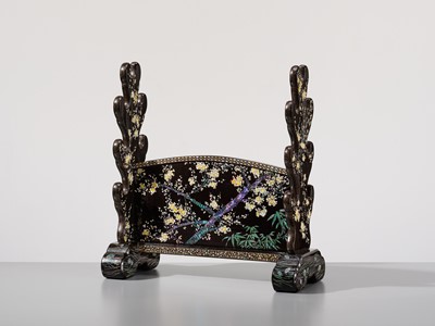 Lot 135 - A SUPERB MOTHER-OF-PEARL INLAID AND BLACK-LACQUERED ‘THREE FRIENDS OF WINTER (SHOCHIKUBAI)’ KATANA-KAKE (SWORD STAND)