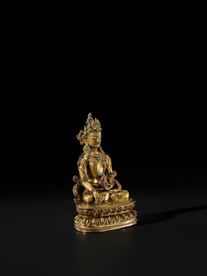 Lot 17 - AN INLAID GILT-BRONZE FIGURE OF AKSHOBHYA, TIBET, 16TH-17TH CENTURY