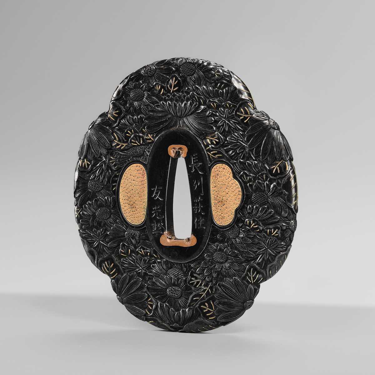 Lot 66 - TOMOMITSU: A FINE SHAKUDO TSUBA WITH KIKU (CHRYSANTHEMUMS)