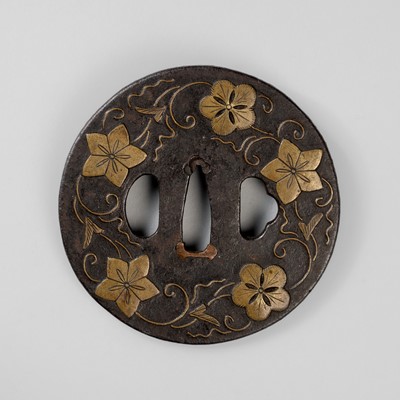 Lot 1830 - AN IRON TSUBA WITH BELLFLOWERS AND PLUM BLOSSOMS