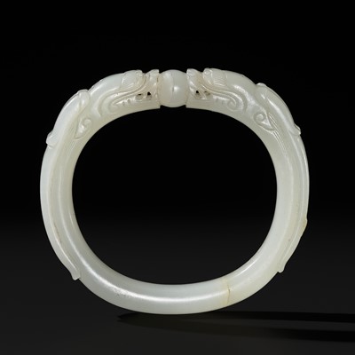 Lot 455 - A WHITE JADE ‘DRAGON’ BANGLE, QING DYNASTY