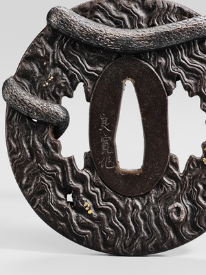 Lot 55 - IWAMOTO RYOKAN: A FINE IWAMOTO SCHOOL IRON TSUBA OF A SNAKE ON A TRUNK