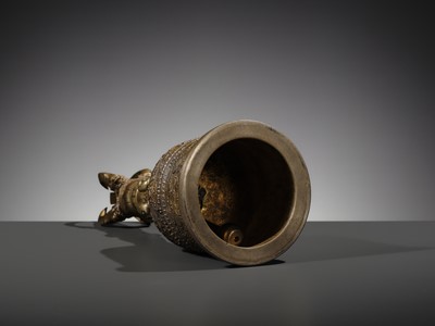 AN UNUSUAL AND LARGE PARCEL-GILT BRONZE FOUR-PRONGED VAJRA BELL