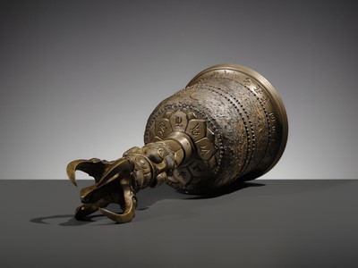 AN UNUSUAL AND LARGE PARCEL-GILT BRONZE FOUR-PRONGED VAJRA BELL