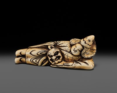Lot 74 - AN EARLY IVORY NETSUKE OF A RECLINING BUGAKU DANCER