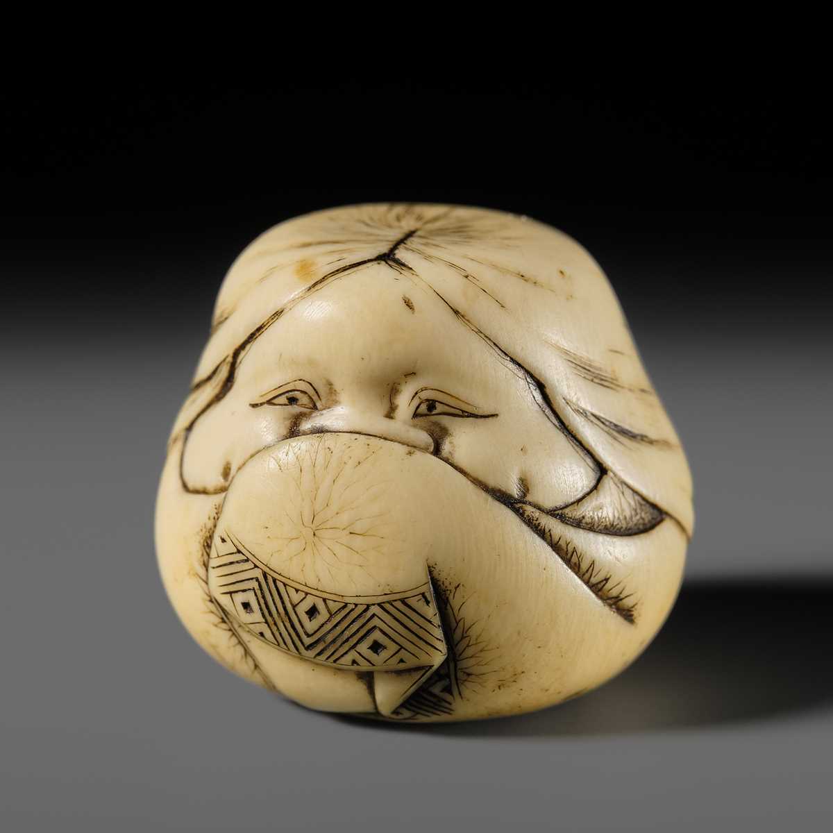 Lot 144 - DOSHO: A FINE OSAKA SCHOOL IVORY NETSUKE OF OKAME AS ONNA DARUMA