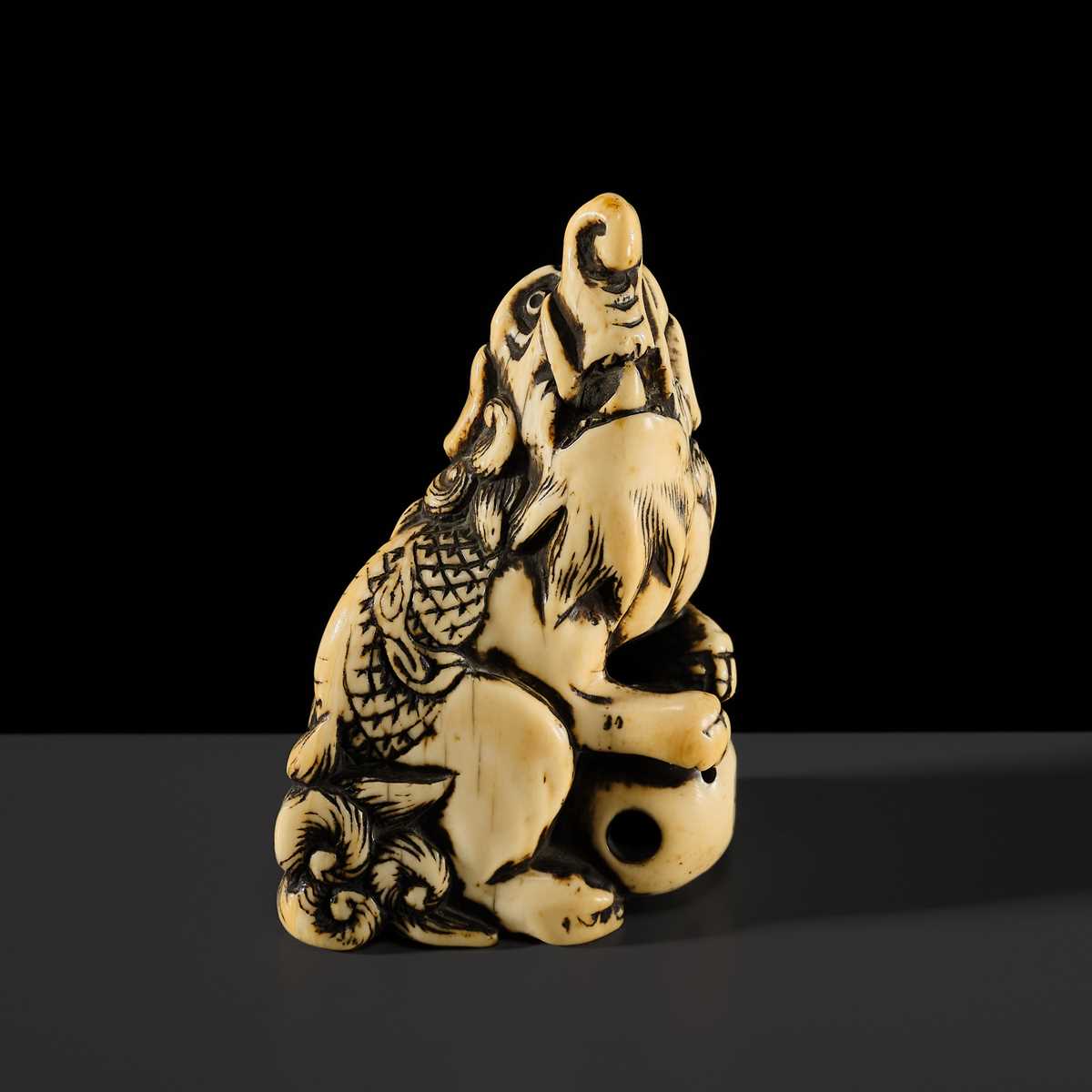 Lot 100 - A POWERFUL AND LARGE IVORY NETSUKE OF A BAKU