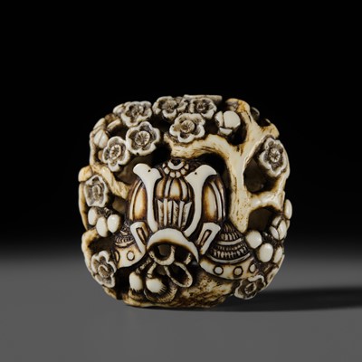 Lot 321 - A DELICATE WALRUS TUSK RYUSA MANJU NETSUKE OF A KABUTO (HELMET) UNDER A PRUNUS TREE