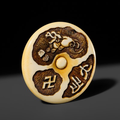 Lot 337 - KOKUSAI: A VERY FINE IVORY MANJU NETSUKE WITH A SHISHI
